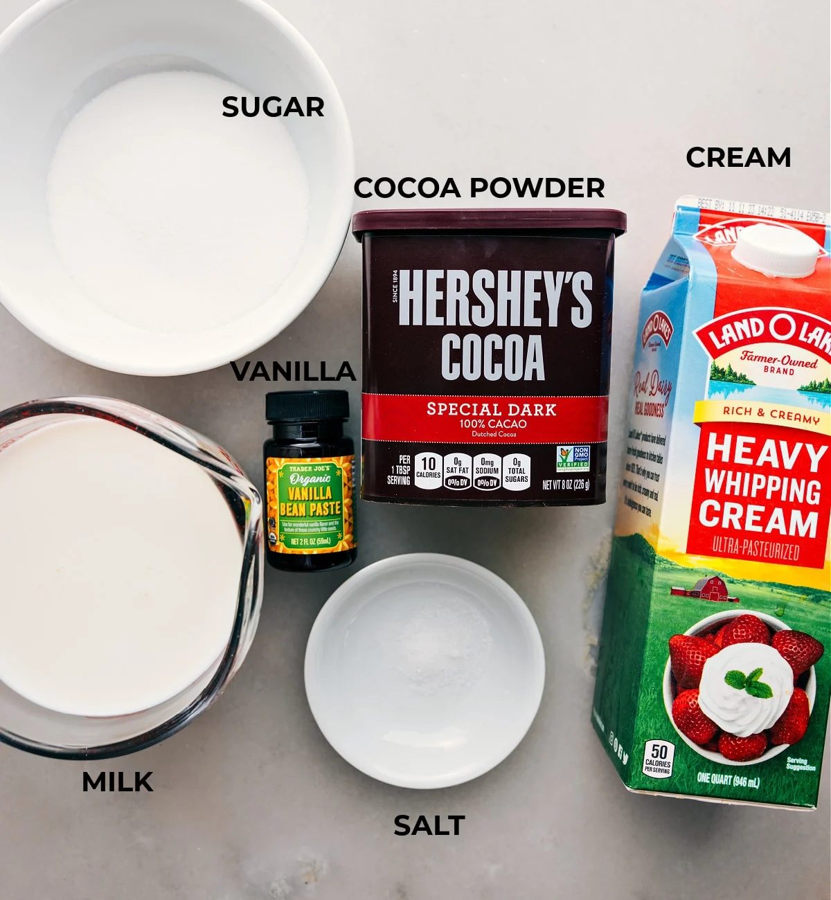 Ingredients laid out for slow cooker Hot Chocolate, featuring cream, cocoa powder, sugar, and other essentials.