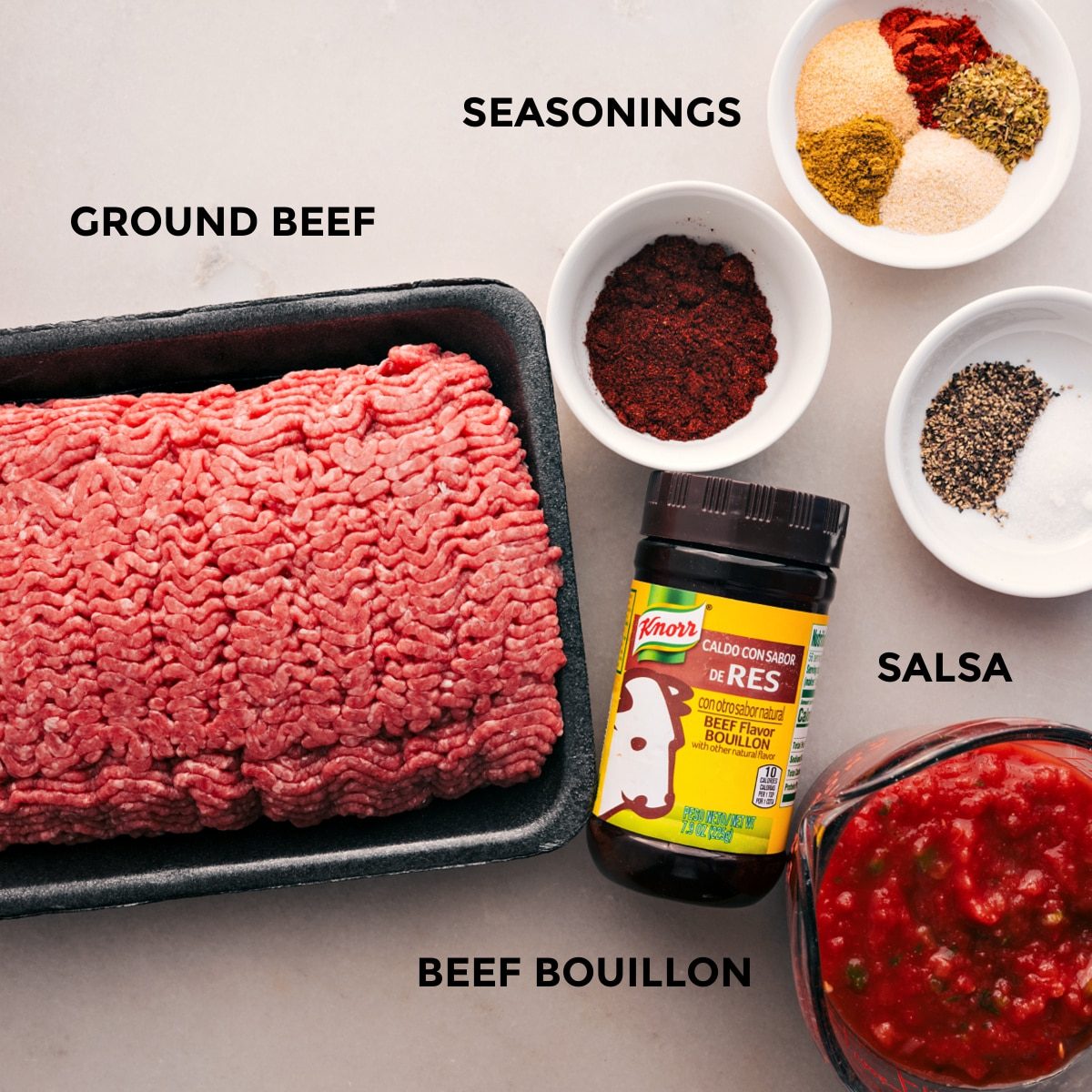 All the ingredients for this recipe prepped for straightforward assembly, including ground beef, seasonings, and salsa.