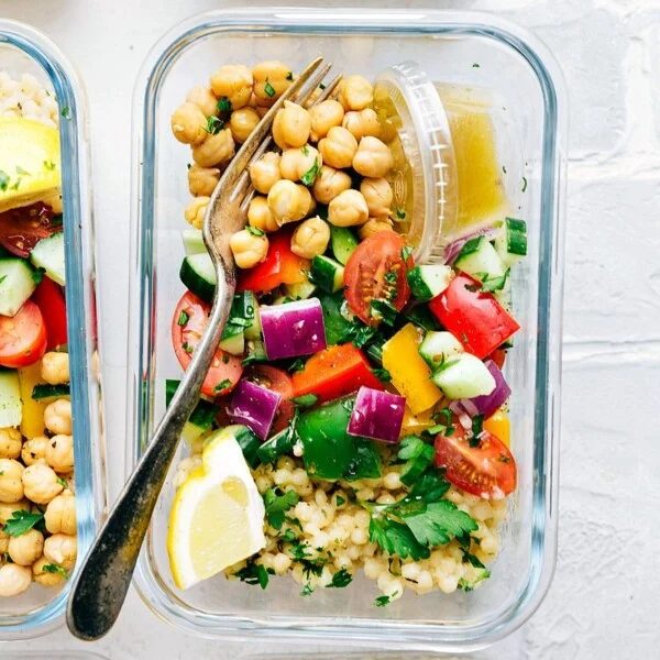 Greek couscous salad in a glass container for lunch.