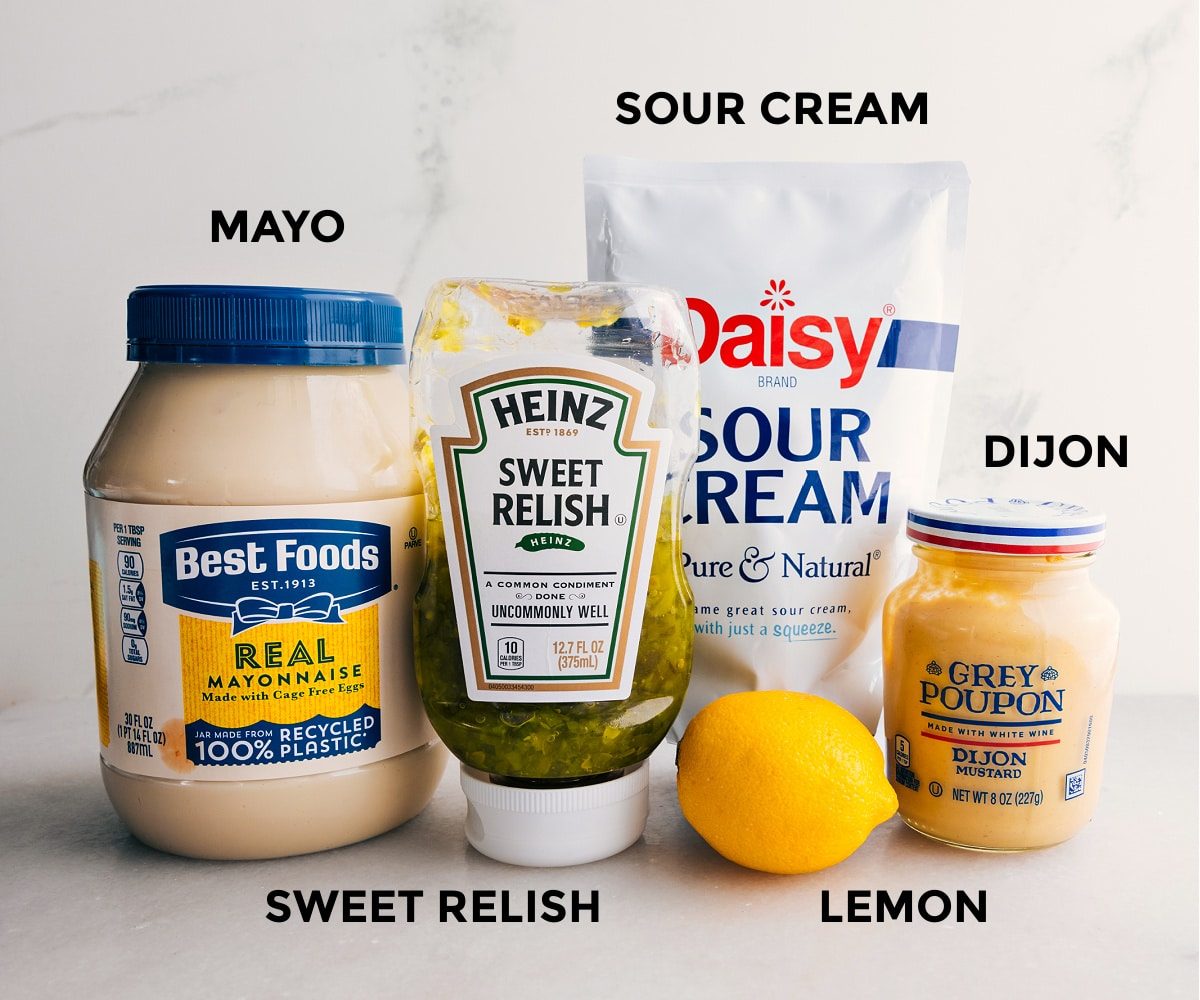 Prep the sauce ingredients for straightforward assembly: mayo, relish, mustard, lemon, and sour cream.