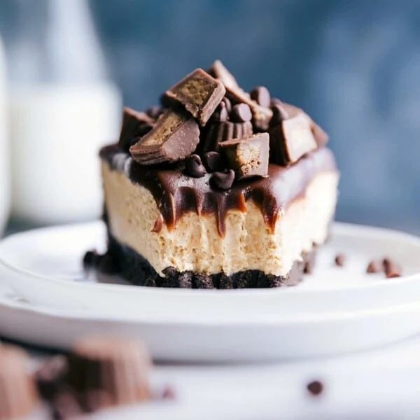 A slice of peanut butter cheesecake no bake with a bite taken out, revealing its soft and creamy interior.