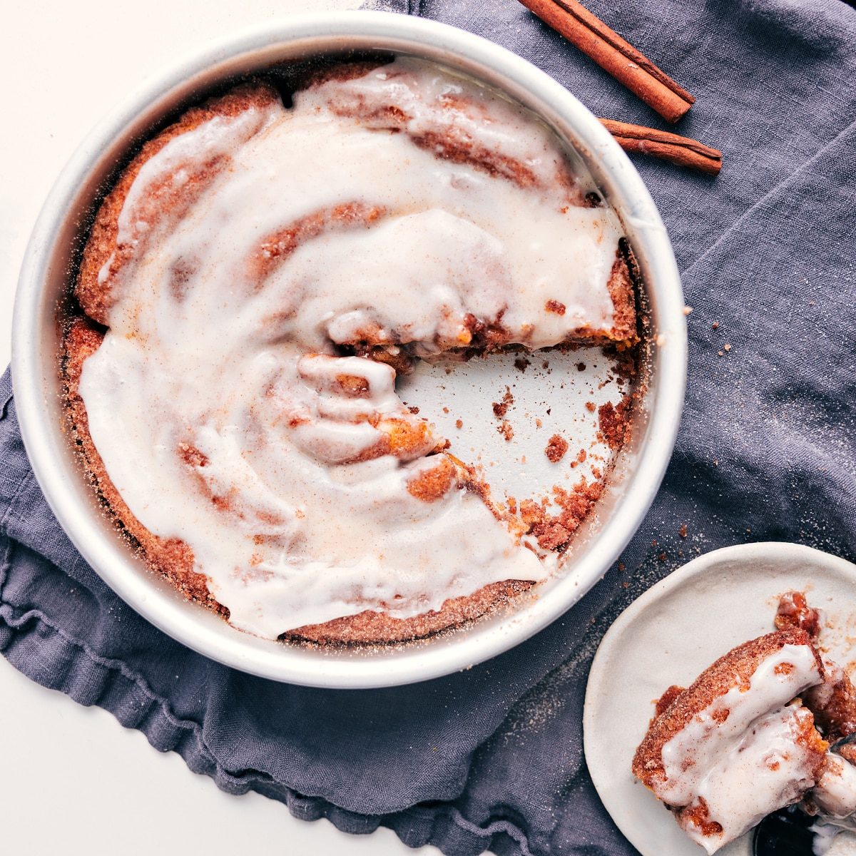 A slice of this cinnamon roll cake recipe taken out of the pan to be enjoyed.