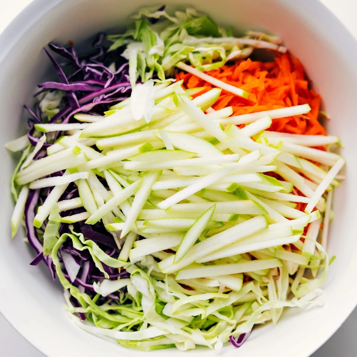 Base ingredients for the straightforward Coleslaw Recipe added to a bowl.
