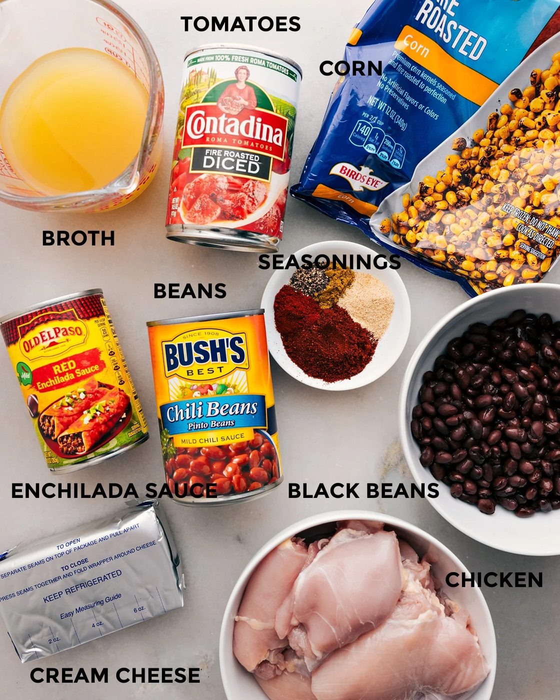 Prep all the ingredients for this recipe, including tomatoes, broth, beans, seasonings, corn, meat, enchilada sauce, and cream cheese, for straightforward assembly.
