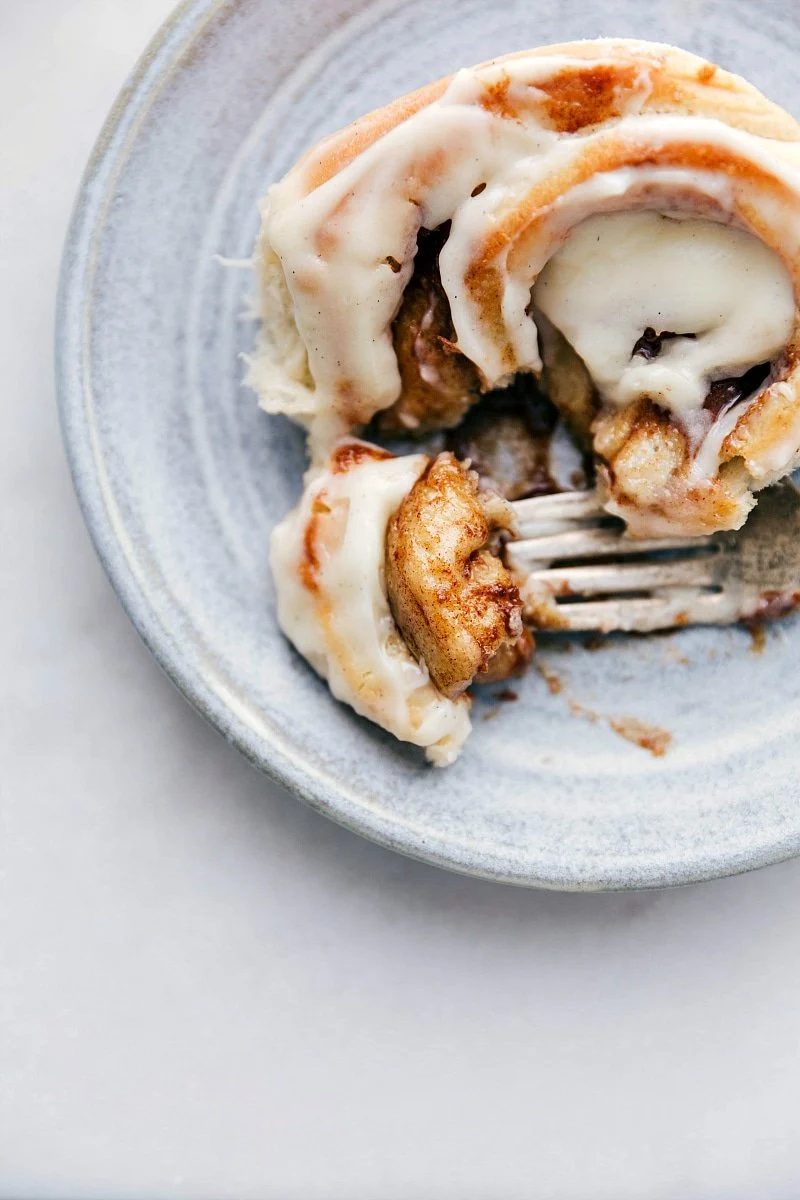 from-scratch Cinnamon Roll with bite taken out of it.