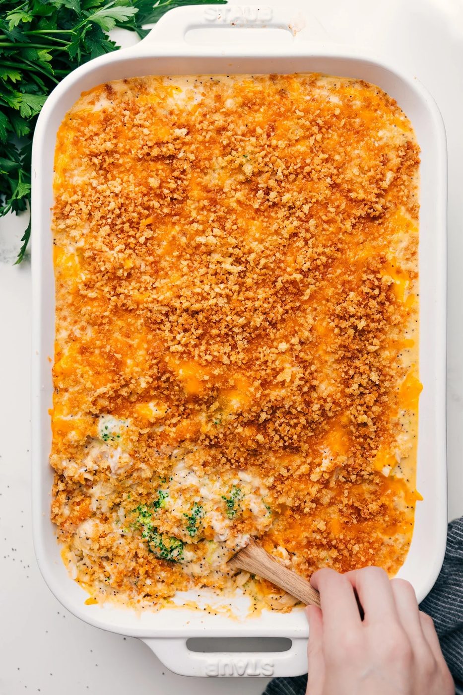 Creamy poppy seed chicken casserole with rice, broccoli, cheese, and a buttery cracker topping.