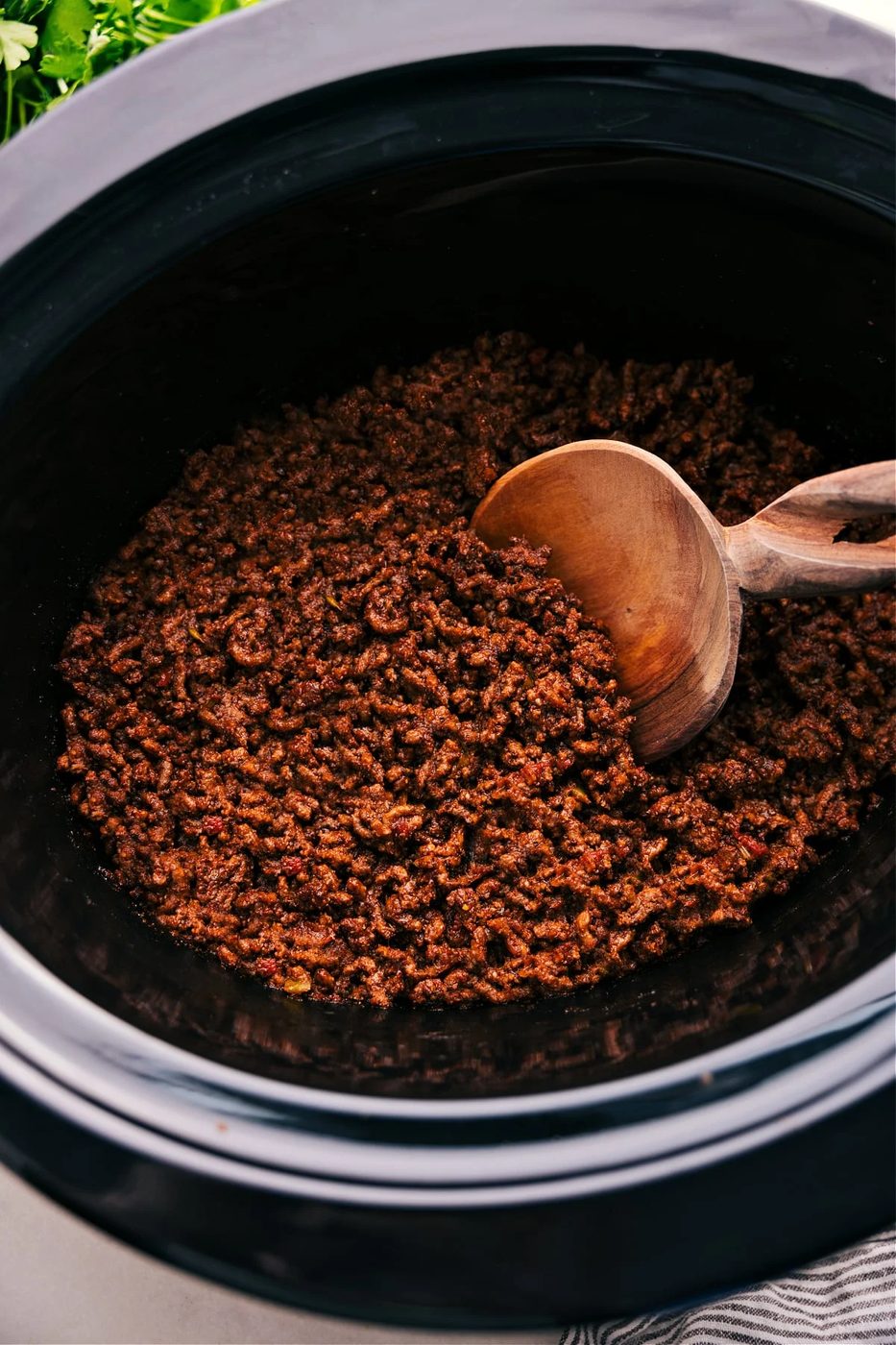 Tender seasoned taco meat cooking in a slow cooker for a simple family meal.