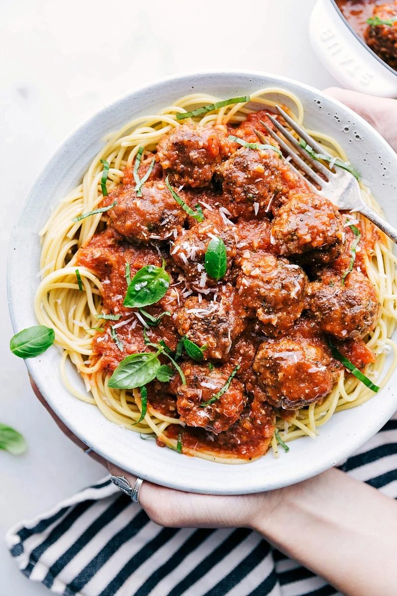 Mozzarella-stuffed meatballs in marinara are hearty straightforward recipes for kids served over pasta.
