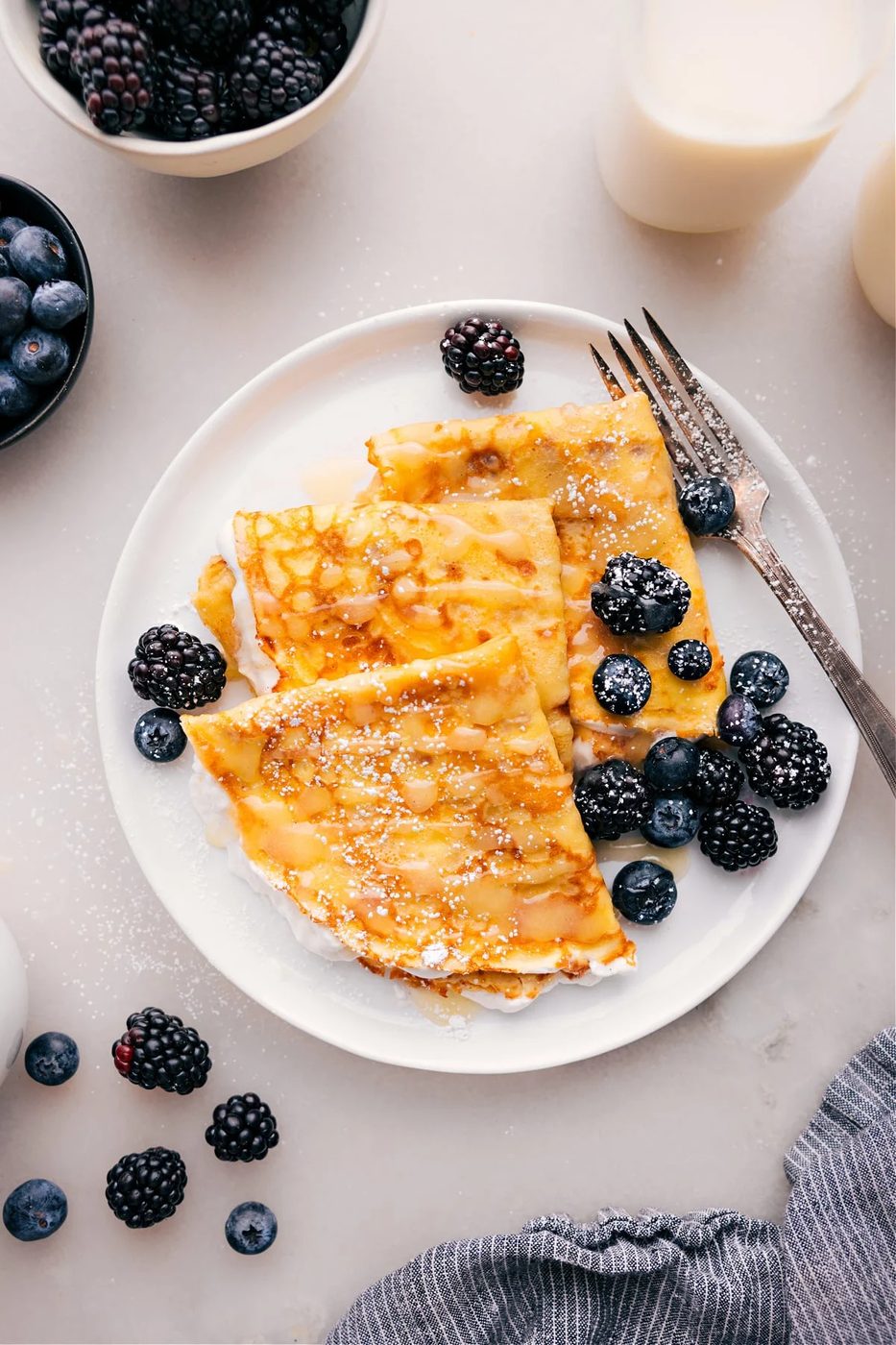 Light from-scratch crepes with berries, cream, and chocolate spread for sweet and straightforward recipes for kids.