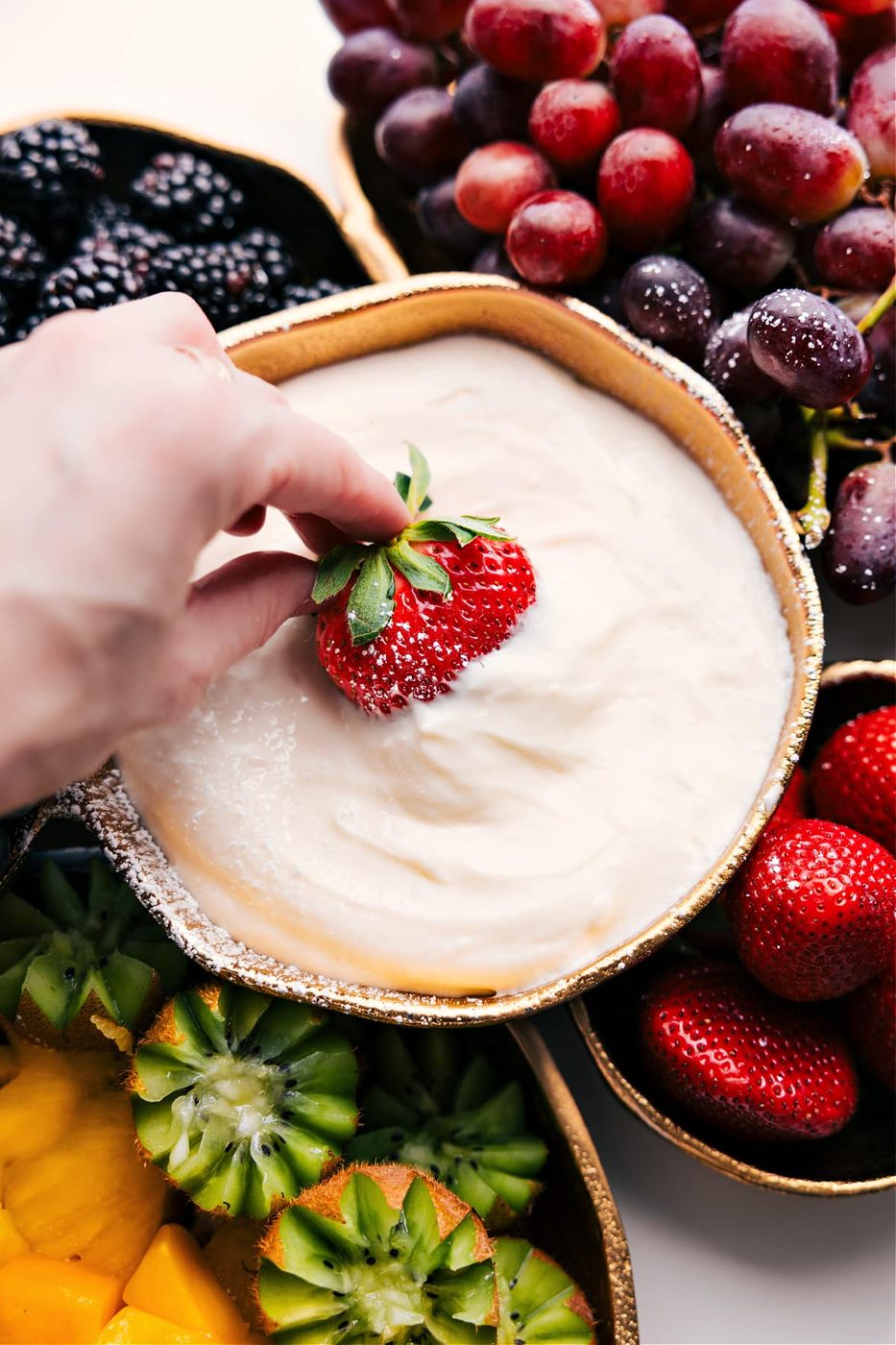 Creamy lime fruit dip served with a colorful assortment of fresh fruit.