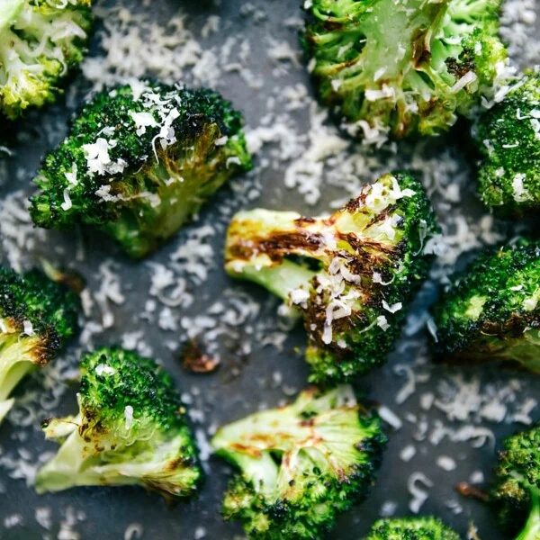 Baked vegetables fresh out of the oven, topped with parmesan cheese, adding a reliable complimentary flavor.