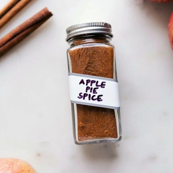 Container of fragrant apple pie spice, a versatile spice blend.
