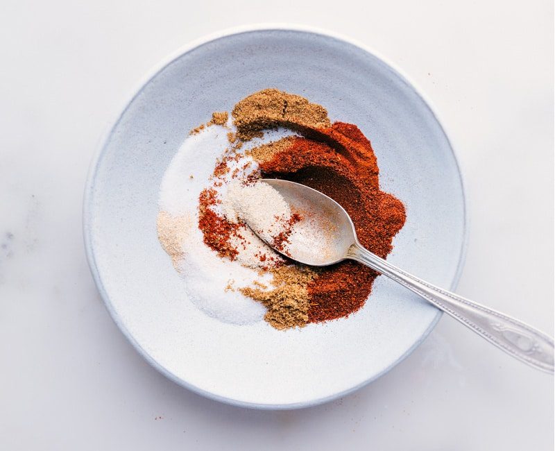 Chicken fajita seasoning recipe ingredients measured and added to a bowl, ready to mix into a from-scratch spice blend recipe.