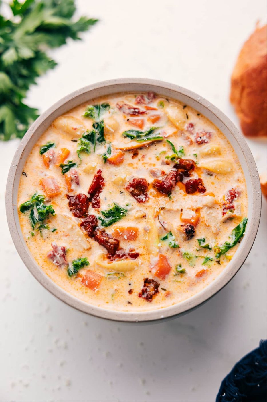 Marry me chicken soup with chicken, pasta, kale, sun-dried tomatoes, and creamy Parmesan broth.