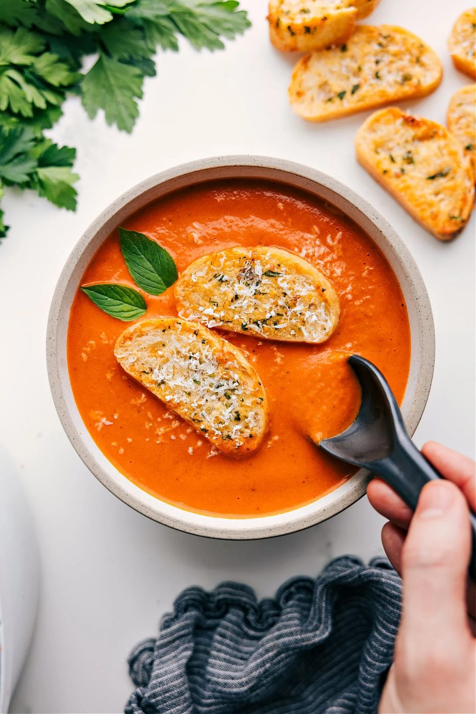 Creamy tomato soup with basil served with Parmesan garlic crostini.