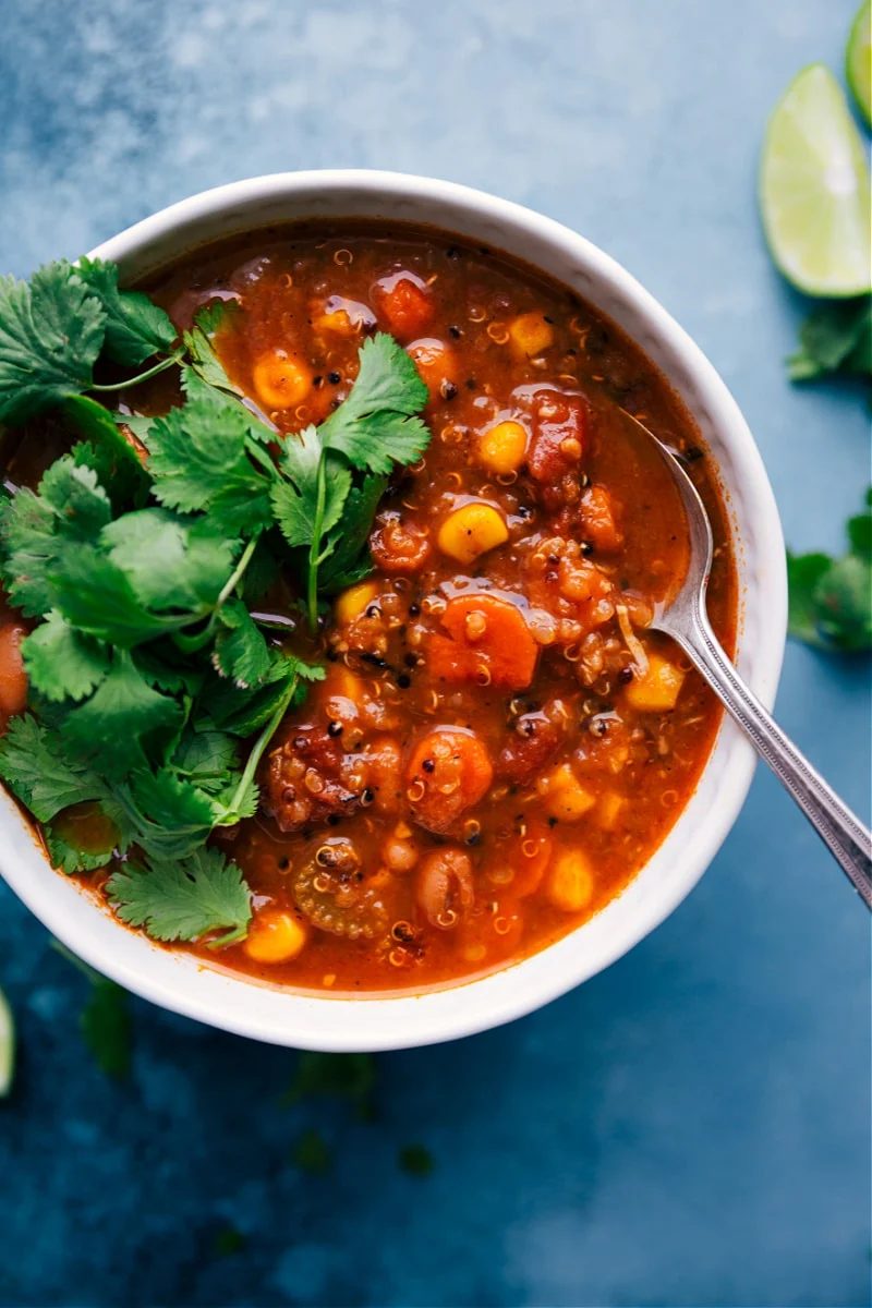 Hearty quinoa soup with shredded chicken, vegetables, quinoa, and warm spices.