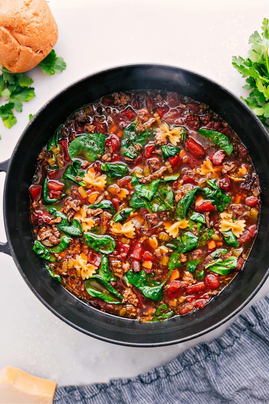 Pasta soup with Italian sausage, spinach, and tender pasta in a cozy bowl, one of these fall soup recipes.