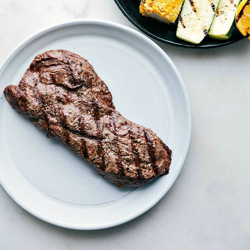 A evenly grilled steak from this straightforward flat iron steak recipe, sliced and ready to serve.