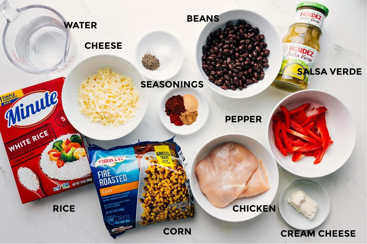 All the ingredients prepped and ready for straightforward assembly, including water, rice, cheese, corn, spices, beans, chicken, salsa verde, cream cheese, and peppers.