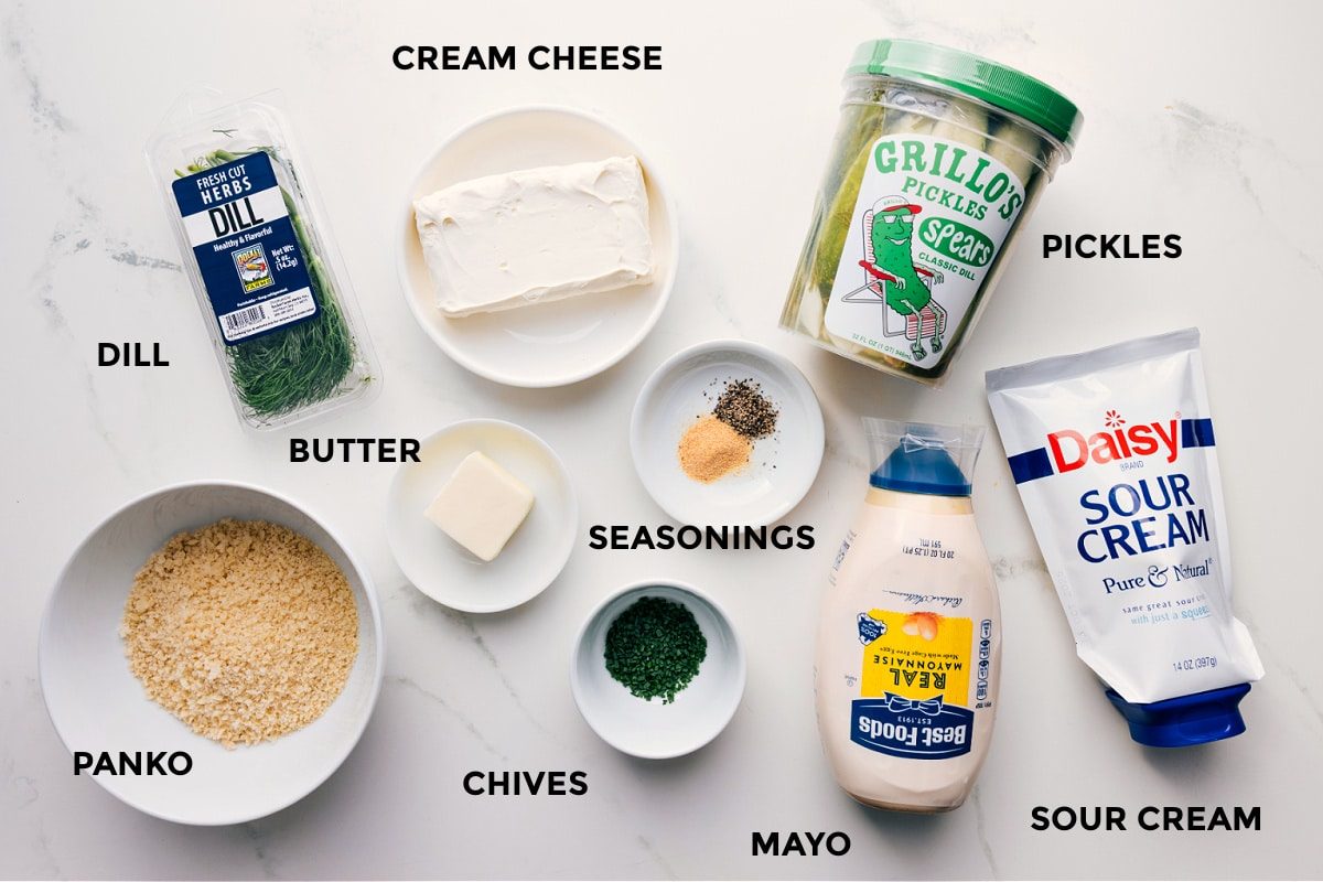 All ingredients prepped for straightforward assembly: dill, cream cheese, panko, butter, seasonings, chives, mayo, sour cream, and pickles.