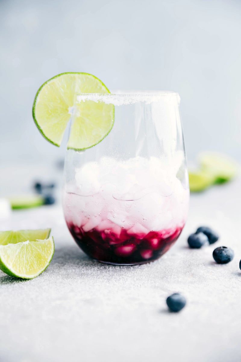 A satisfying blueberry mandarine-lime beverage. This spritzer is non-alcoholic made with a sugared blueberry base and a mandarine-lime sparkling water. I flexfa.com