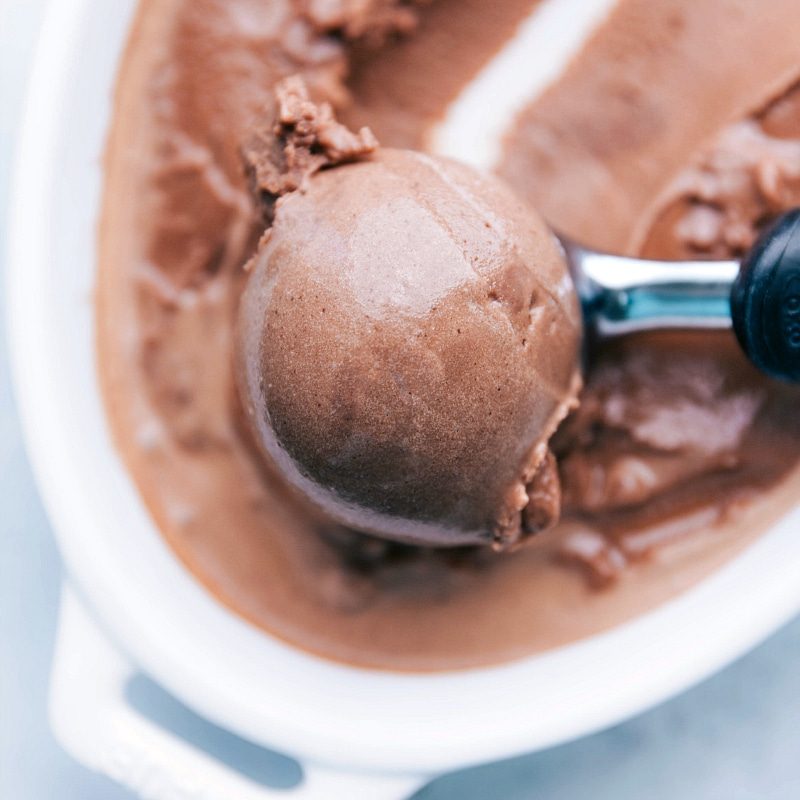 The refreshing and flavorful dessert being scooped up with an ice cream scoop.