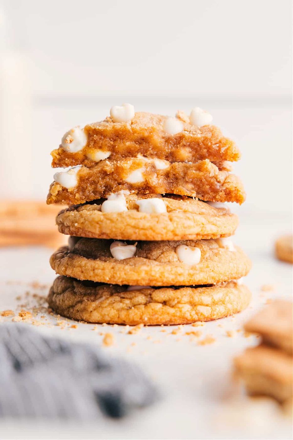 Graham cracker cookies stacked on top of each other with cookies split in half on top to show the insides.