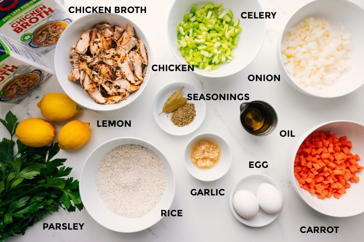 Prepped ingredients including broth, lemon, parsley, rice, chicken, spices, celery, onion, carrot, oil, egg, and garlic.