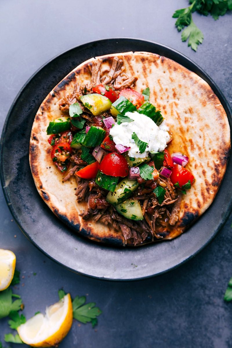 Shredded beef gyros tucked into warm pita and topped with cucumber tomato salad and creamy tzatziki sauce.