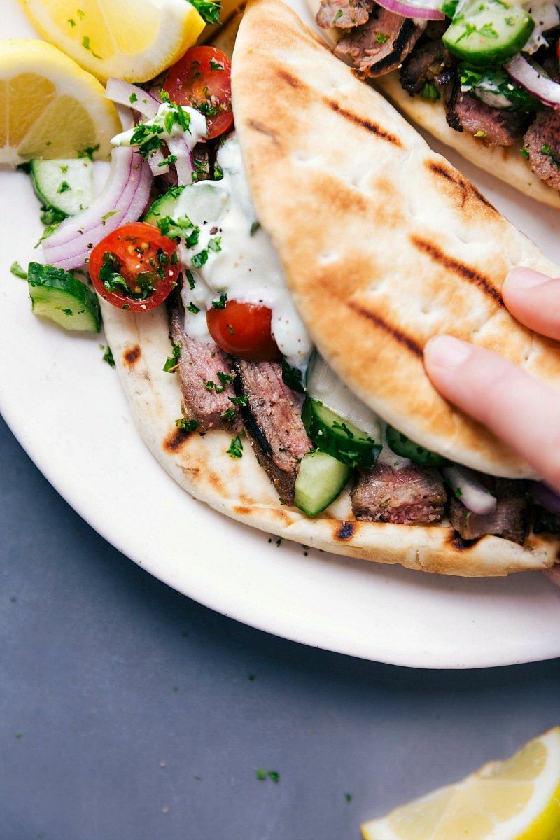 Greek recipes: Steak gyros fully stuffed with succulent meat, fresh vegetables, and a satisfying sauce, ready to be eaten.