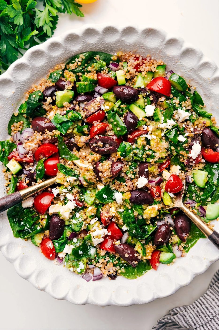 A big quinoa salad in a bowl tossed together and dressed.