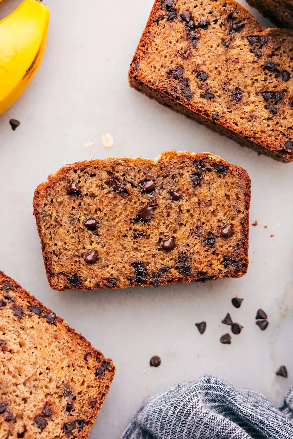 Slices of Healthy Banana Bread Recipe, warm and inviting, with chocolate chips scattered throughout.