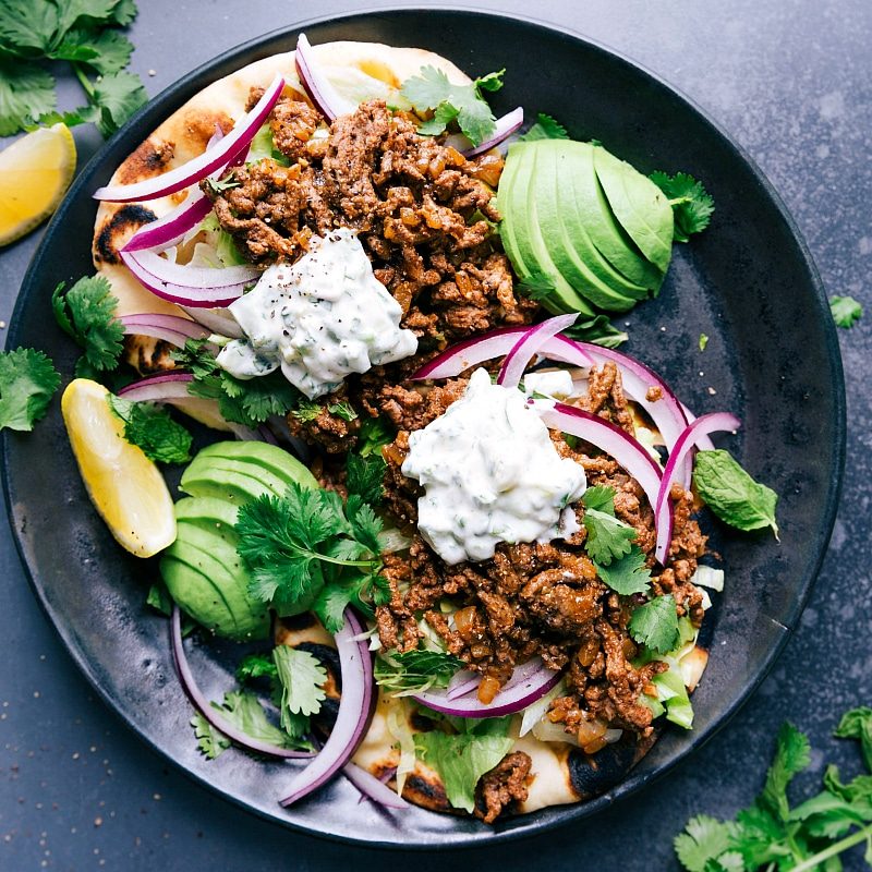 The finished meal topped with satisfying toppings, sauce, and vegetables, creating a satisfying meal.