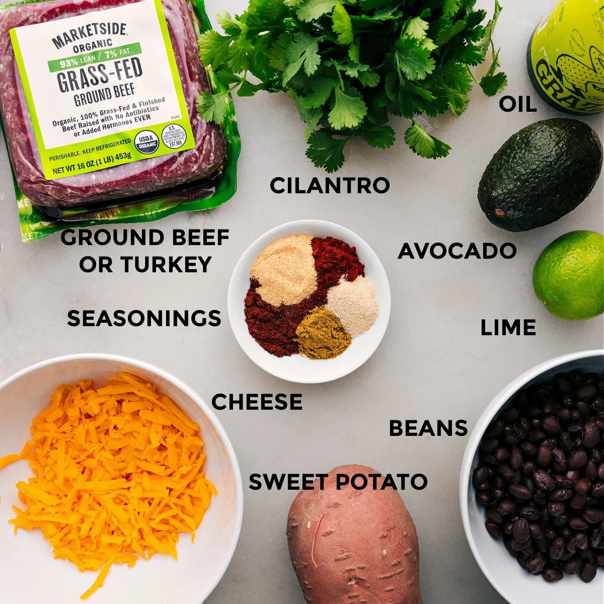 All the ingredients for this recipe are prepped and ready for straightforward assembly, including the meat, cilantro, veggies, beans, and cheese.
