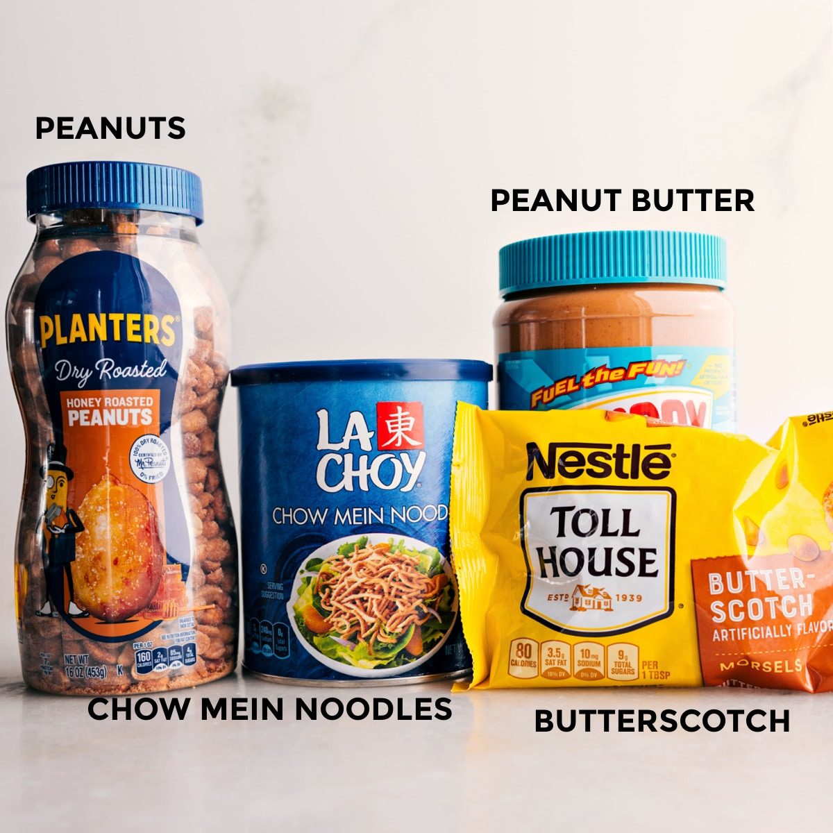The 4 ingredients in this recipe are prepped for straightforward assembly: peanuts, chow mein noodles, butterscotch, and peanut butter.