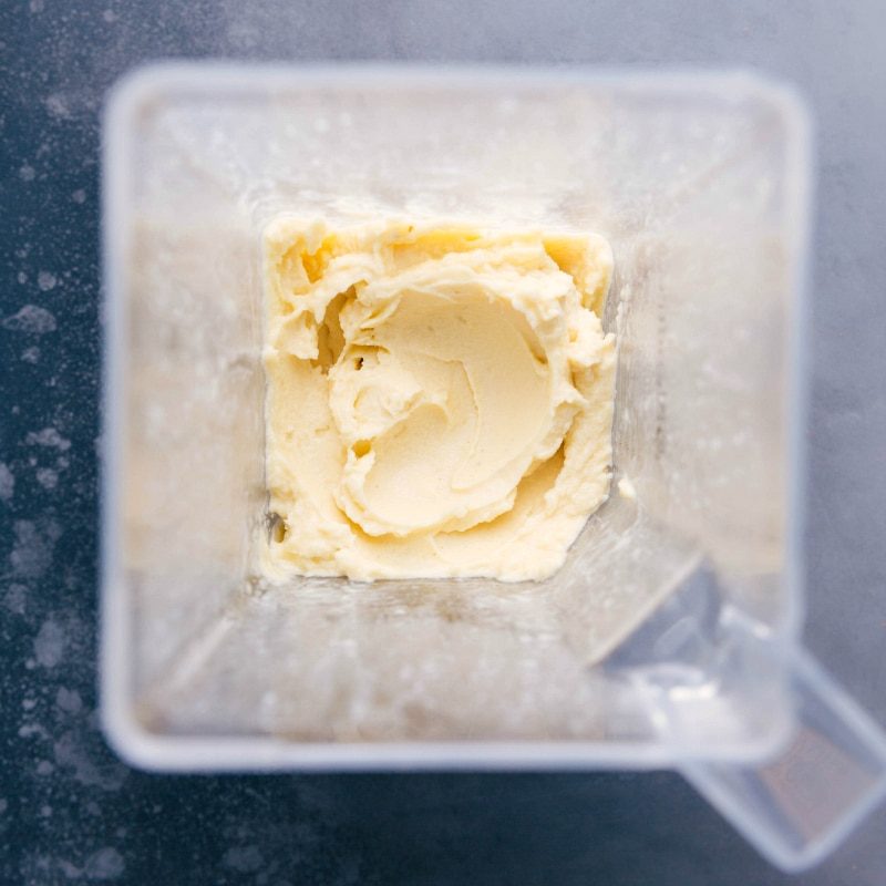 Creamy pineapple mixture in a blender, evenly blended.