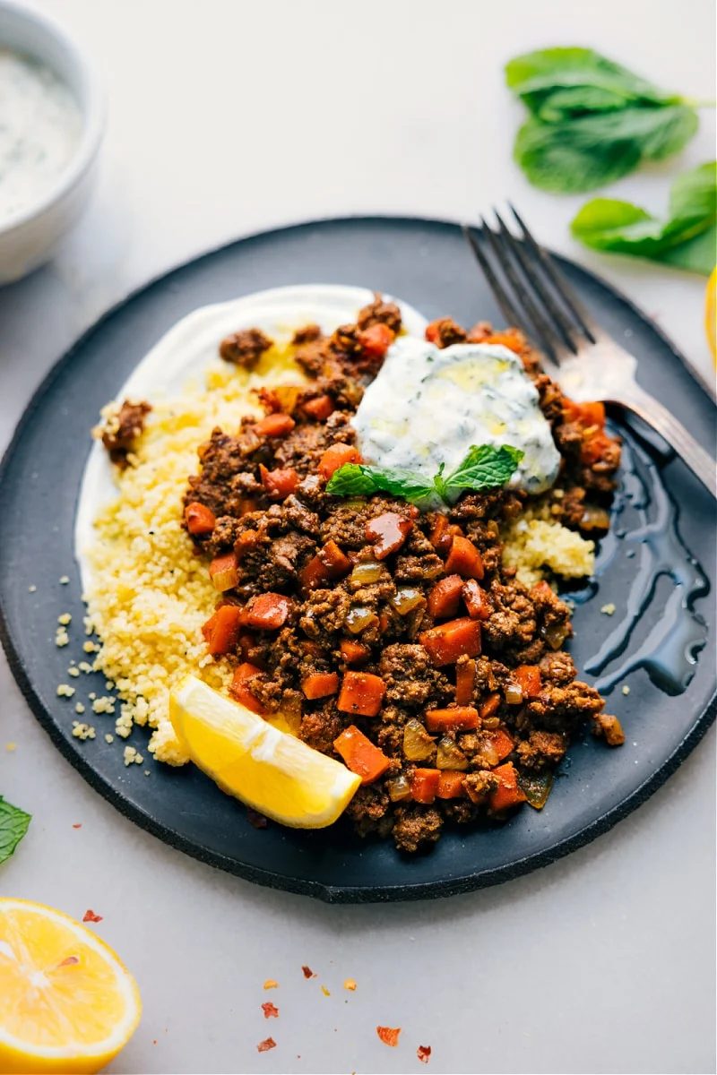 Middle Eastern ground beef bowls with the mint yogurt sauce on a bowl.