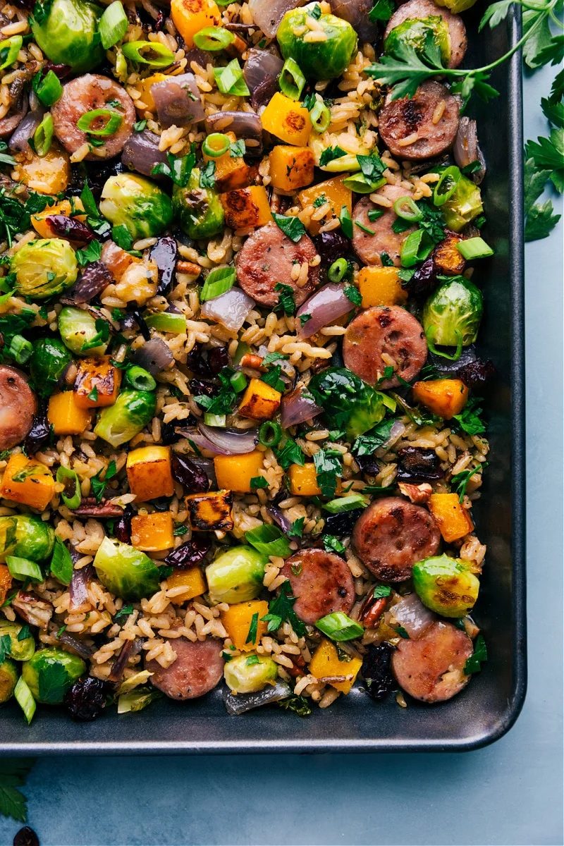 Wild rice pilaf with butternut squash, Brussels sprouts, chicken sausage, cranberries, and pecans.