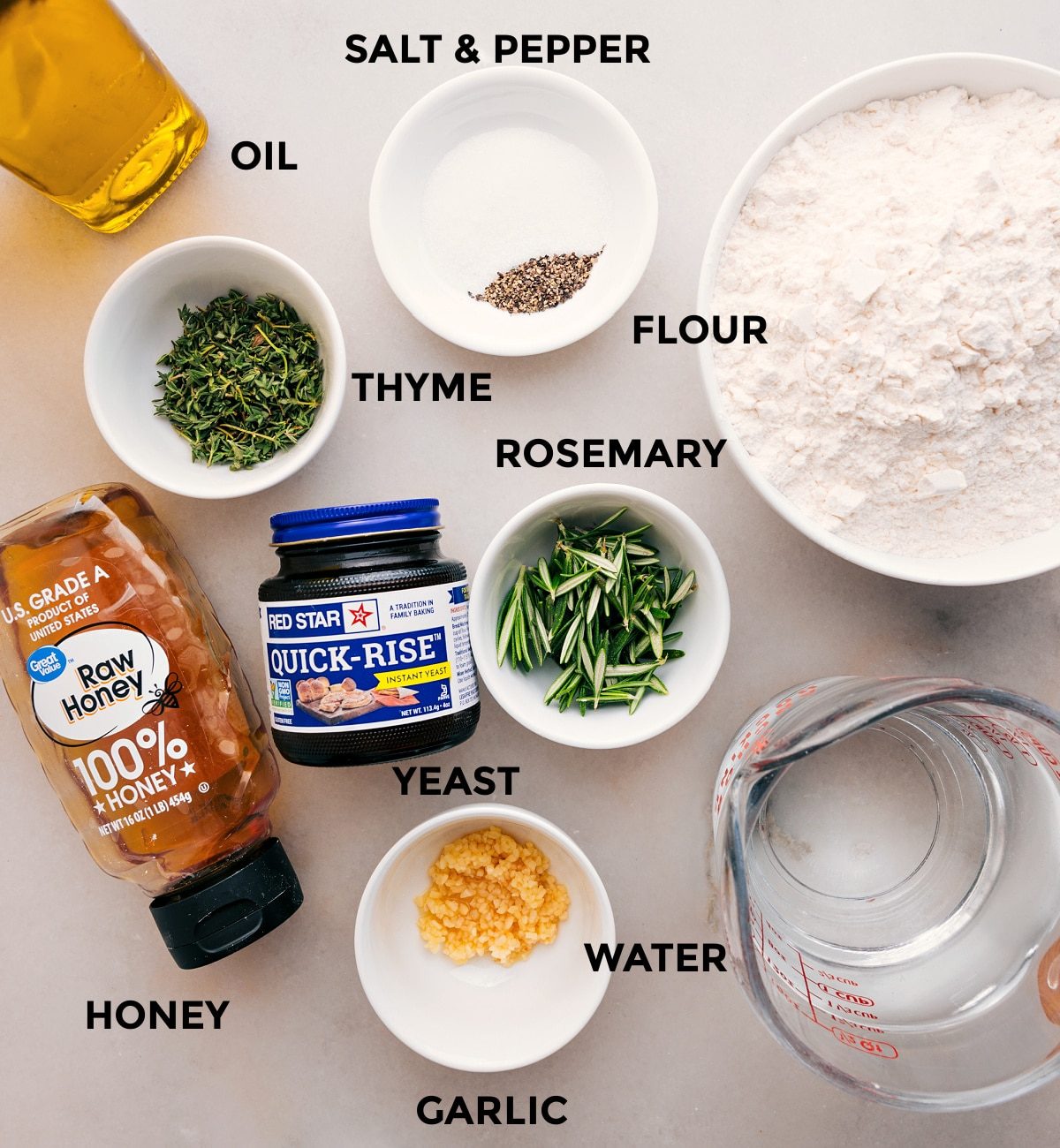 This recipe's ingredients—flour, oil, thyme, rosemary, yeast, water, and honey—are prepped and ready for straightforward assembly.