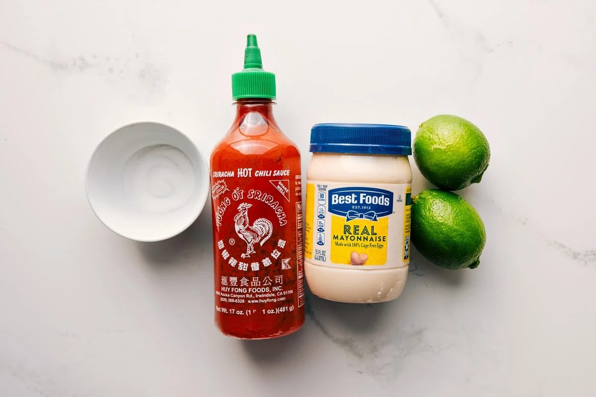 Sugar, mayonnaise, lime, and sriracha prepped for straightforward assembly of the quick sauce.