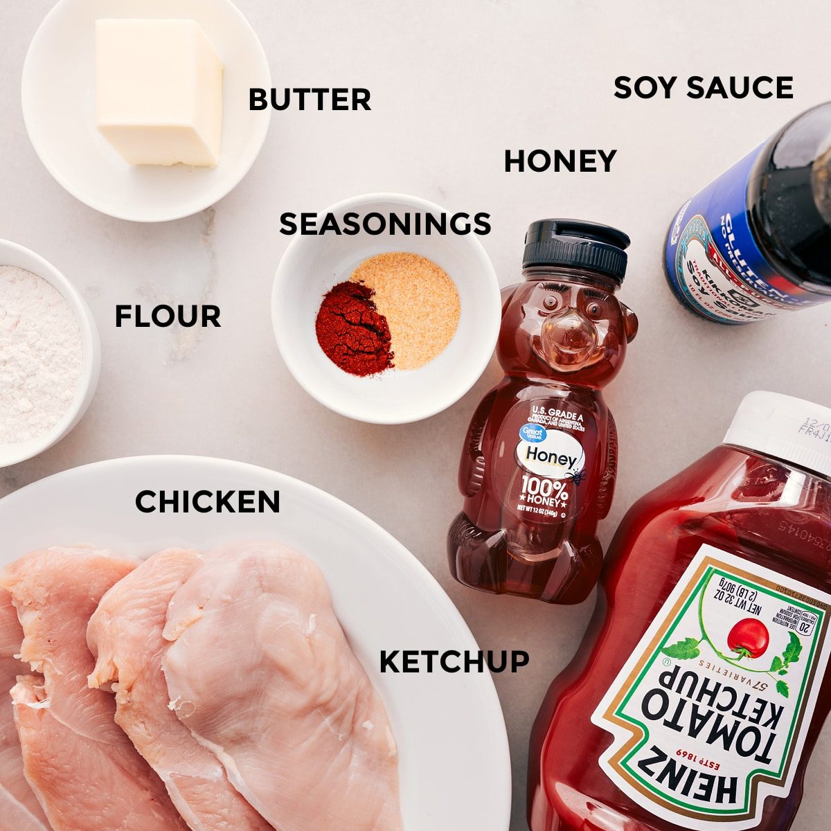 All the ingredients for this recipe are prepped and ready for straightforward assembly: butter, soy sauce, honey, seasonings, ketchup, meat, and flour.