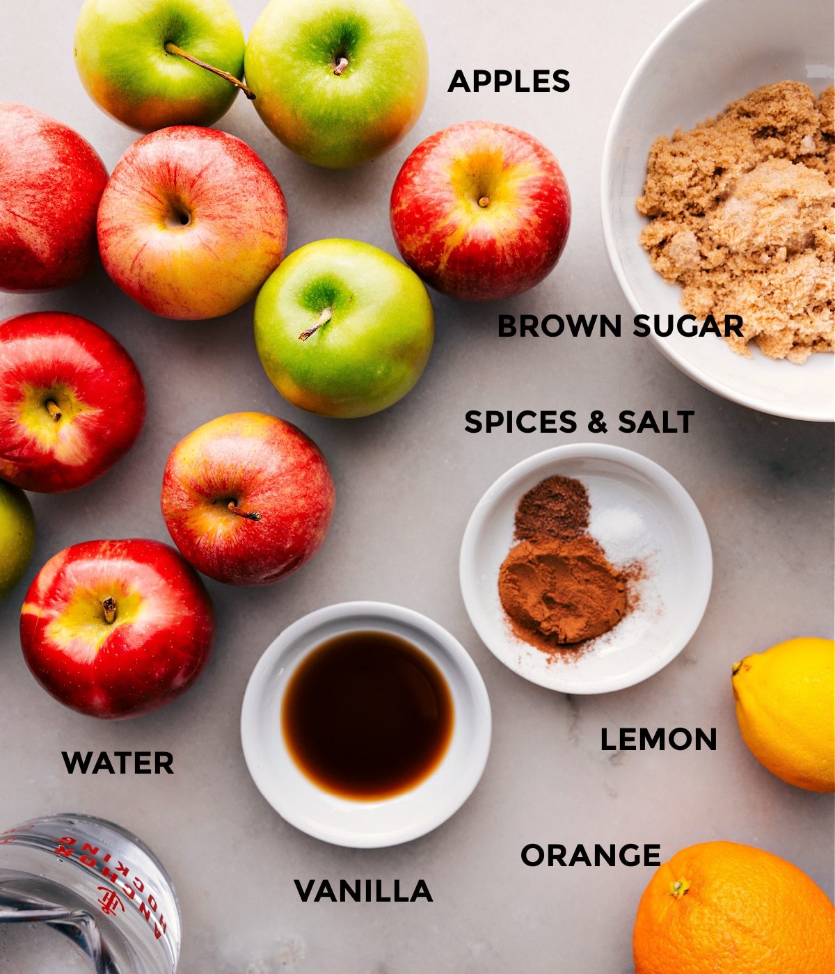 The ingredients used in this recipe including the apples, brown sugar, vanilla, and spices.