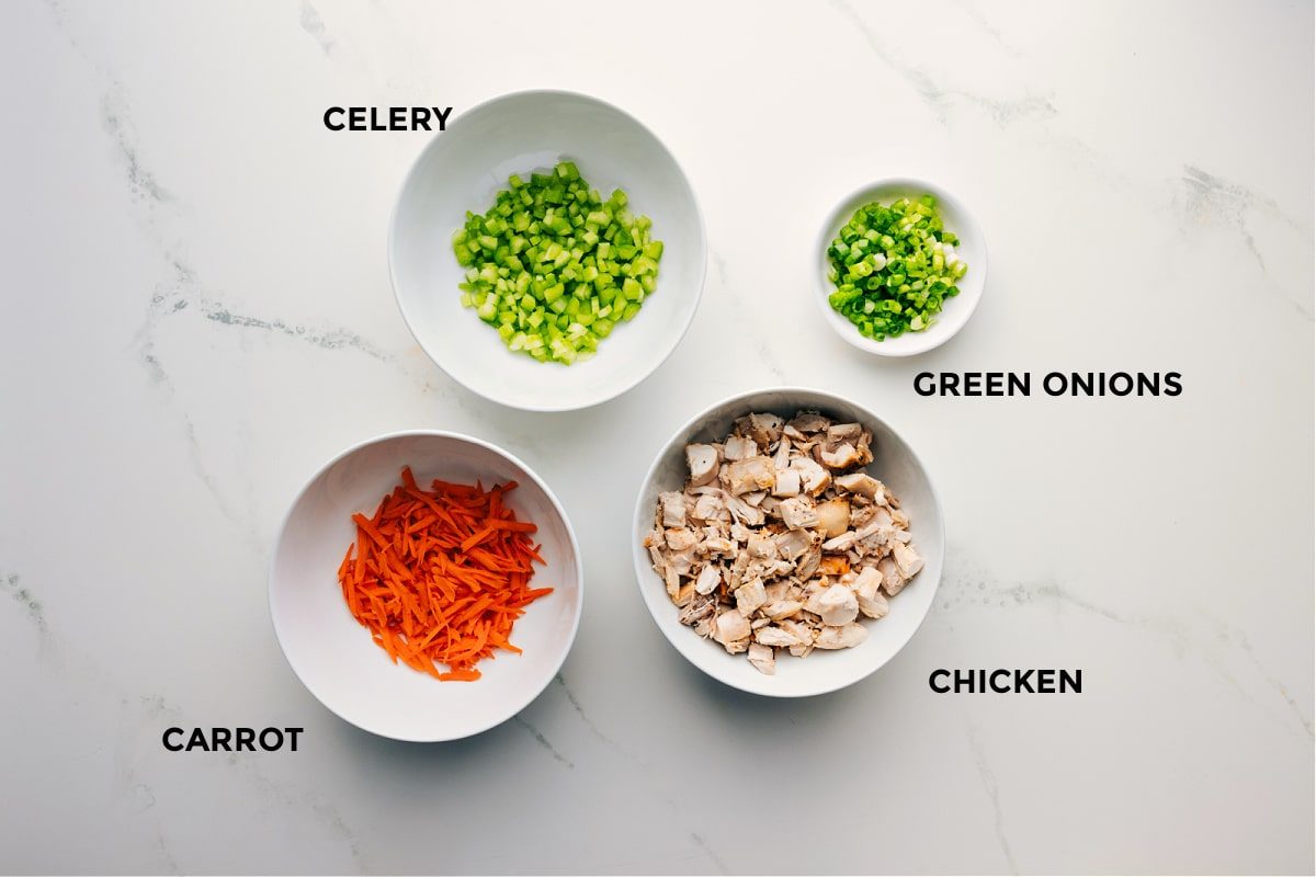 Ingredients prepped out for straightforward assembly including celery, carrot, green onions, and chicken.