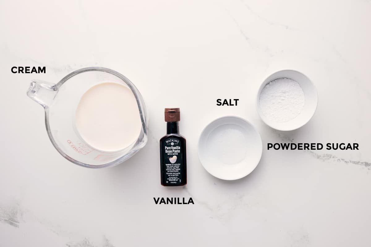 All the ingredients in this recipe prepped out for straightforward assembly including the cream, vanilla, salt, and powdered sugar.