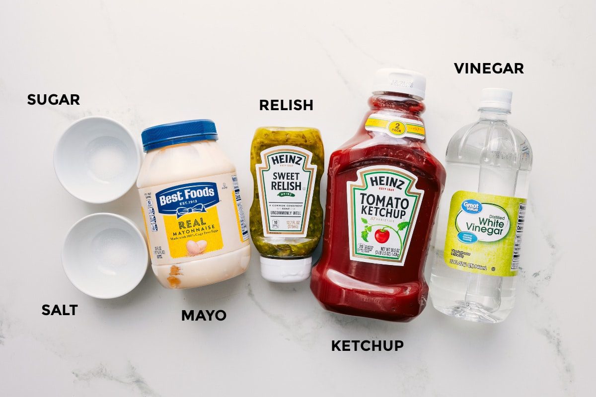 All the ingredients in this recipe prepped out for straightforward assembly including the sugar, salt, mayo, relish, ketchup, and vinegar.