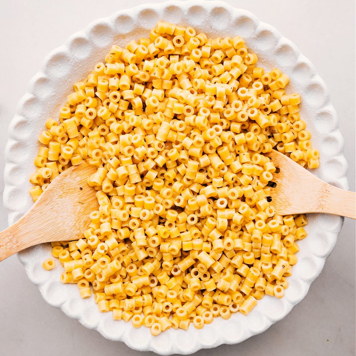 Cooked pasta sits in a bowl, ready to toss with the other ingredients for this Italian Grinder Pasta Salad.