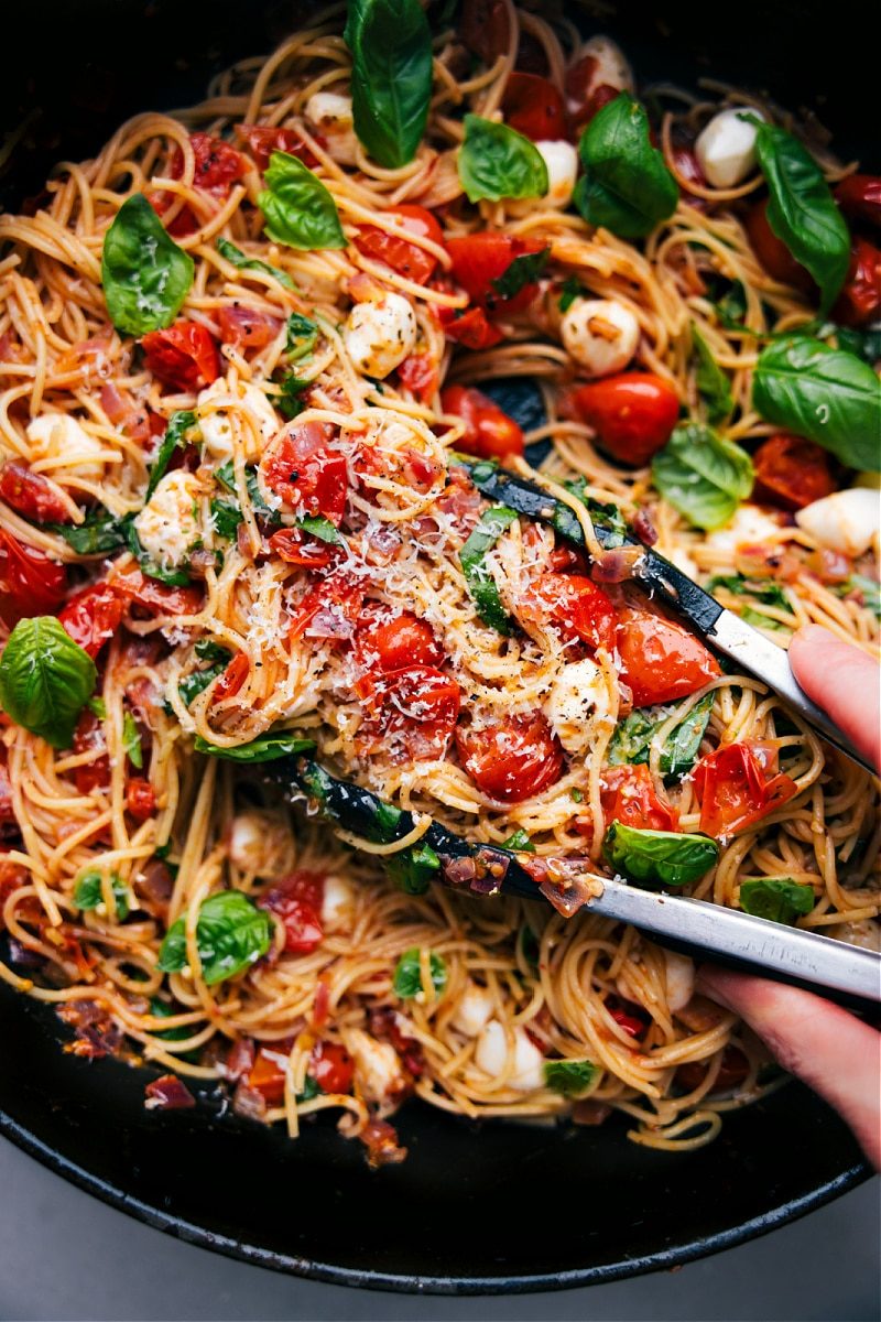 Italian recipes Caprese pasta with tomatoes, basil, mozzarella, balsamic, and angel hair pasta.