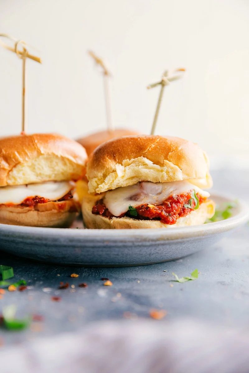 Italian recipes meatball sliders with saucy meatballs, melted cheese, and soft rolls.