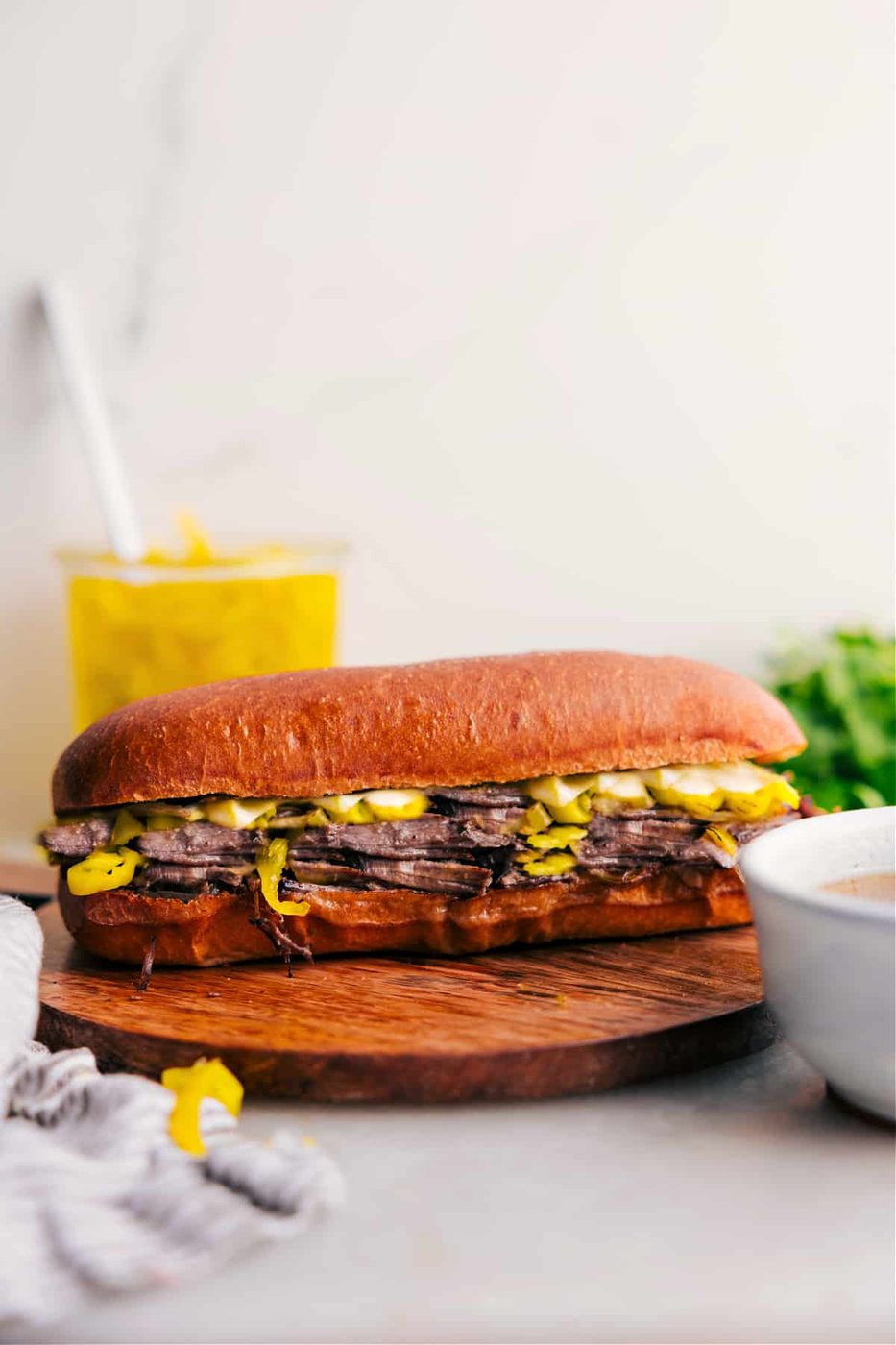 Italian recipes beef sandwich with tender beef, melted cheese, and crusty bread for dipping.