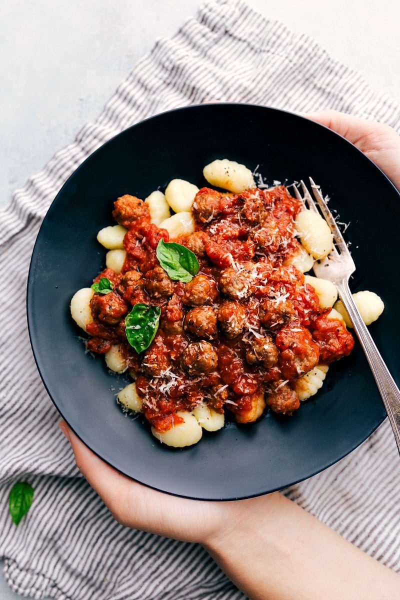 Italian recipes gnocchi with tender pasta, tomato sauce, and mini sausage meatballs.